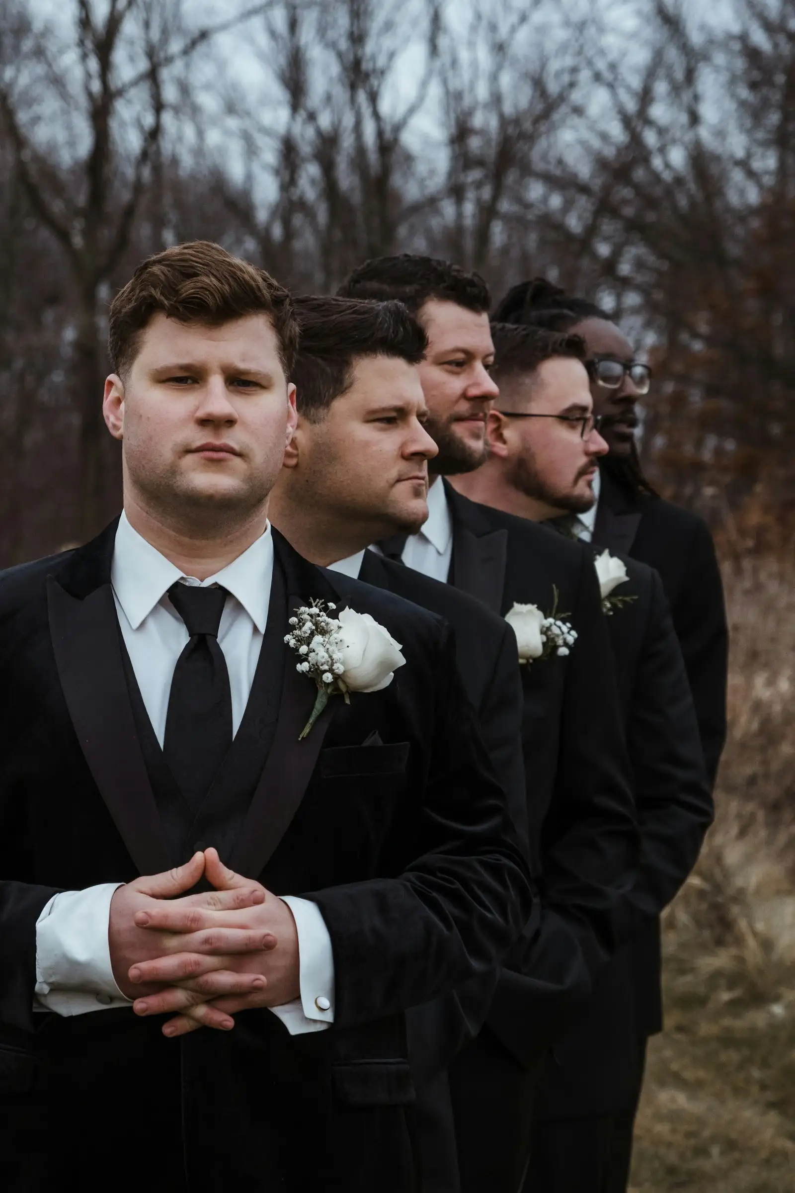A groom with his groomsmen in matching suits