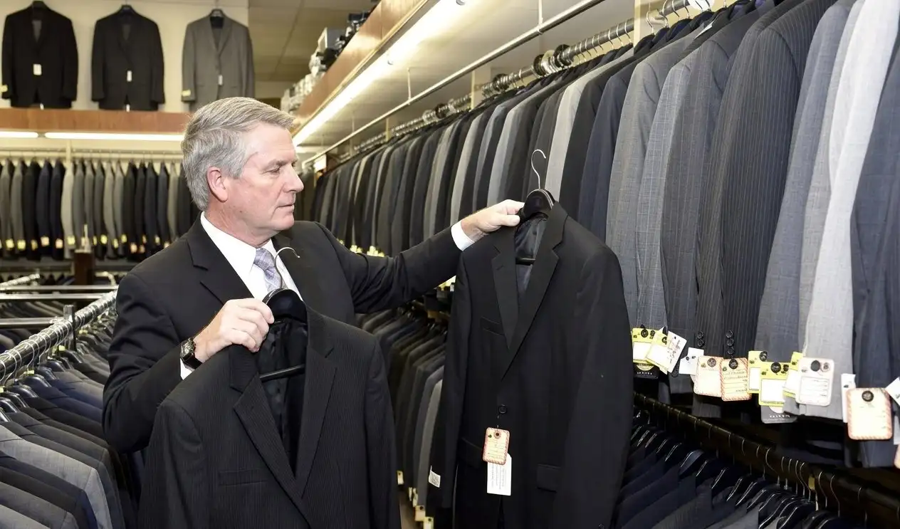 Tony Weber selecting a suit jacket in the store