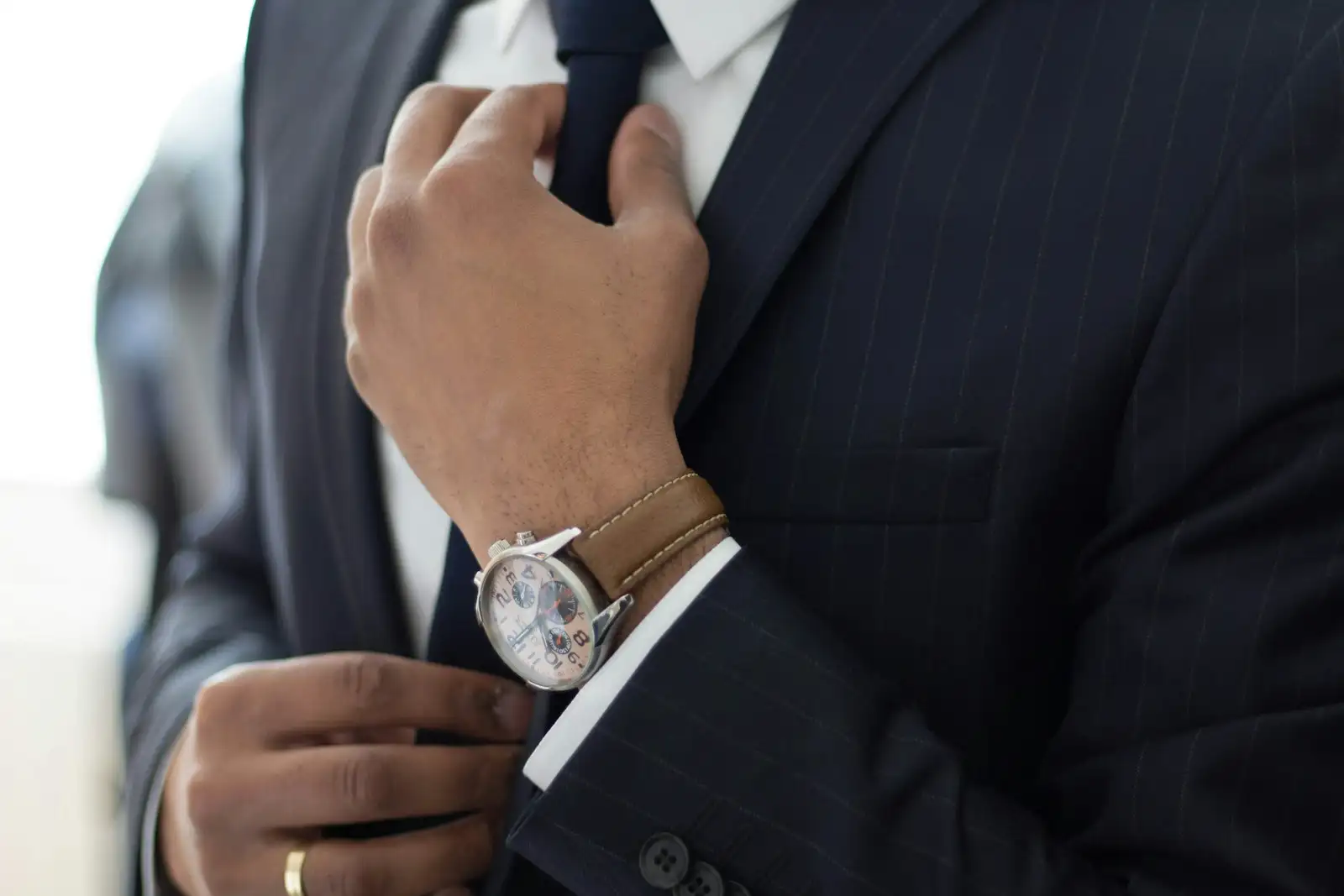 A watch against a suit cuff